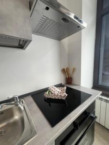 a kitchen with a sink and a stove top oven at Lemon Suite - Titty's Studio - Limone Piemonte in Limone Piemonte