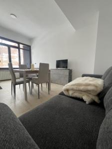 a living room with a couch and a table with chairs at Lemon Suite - Titty's Studio - Limone Piemonte in Limone Piemonte