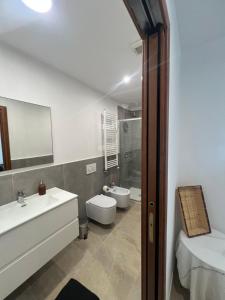 a white bathroom with a sink and a toilet at Lemon Suite - Titty's Studio - Limone Piemonte in Limone Piemonte +11 photos