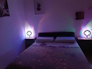 a bedroom with a bed with two lights on it at B&B San Francesco in Molfetta