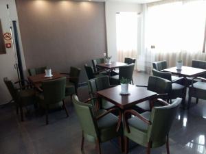 a dining room with wooden tables and chairs at Tokalis Boutique Hotel & Spa in Nea Anchialos