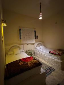 a bedroom with two beds in a room at Soliman House Siwa in Siwa
