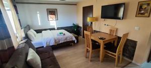 a small living room with a bed and a table at Guliban in Kruševo