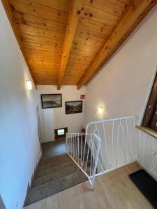 a staircase in a house with a wooden ceiling at Appartement Mittagskogel in Velden am Wörthersee +49 photos