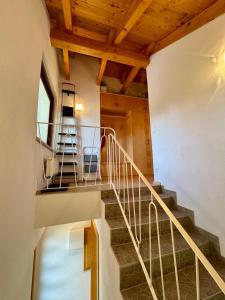 a staircase in a house with two chairs and a ladder at Appartement Mittagskogel in Velden am Wörthersee