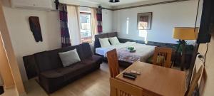 a small living room with a couch and a bed at Guliban in Kruševo