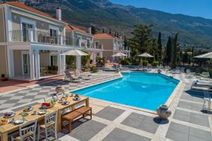 an image of a villa with a swimming pool at Garbis Villas & Apartments in Lourdata