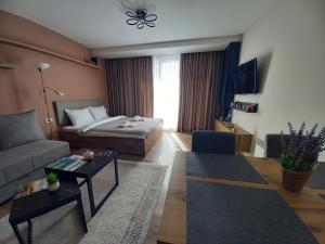 a living room with a couch and a table at Apartman MK Kopaonik in Kopaonik