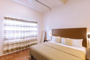 a bedroom with a large bed and a window at Reforma 516 in Oaxaca City
