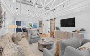 a living room with a couch and chairs and a tv at Three Sisters Bungalow in Santa Rosa Beach