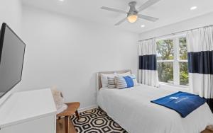 a bedroom with a bed and a ceiling fan at Three Sisters Bungalow in Santa Rosa Beach