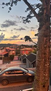 a car parked in a parking lot next to a tree at Tiny House Socorro in Socorro