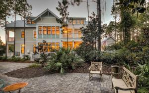 a large white house with a patio in front of it at Watercolor Reunions in Santa Rosa Beach