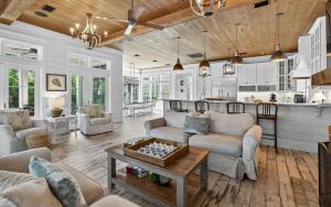 a living room with couches and a table at Watercolor Reunions in Santa Rosa Beach