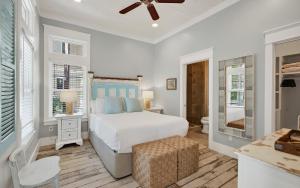 a white bedroom with a bed and a desk at Watercolor Reunions in Santa Rosa Beach +71 photos