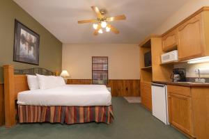 a hotel room with a bed and a kitchen at Westgate Branson Woods Resort in Branson +53 photos