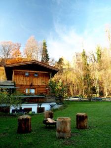 a group of tree stumps in front of a building at Schlossalm Ferienwohnungen in Brannenburg