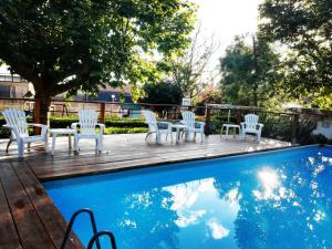 a group of white chairs sitting next to a pool at Camping Smeraldo in Trevignano Romano