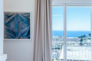 a room with a window with a view of the ocean at Sopramonte Exclusive Rooms in Capri
