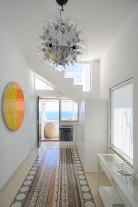 a living room with a chandelier and a table at Sopramonte Exclusive Rooms in Capri