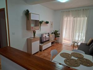 a living room with a table with cookies on it at Casas Holiday - Playa la Mata Laredo in La Mata