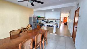 a kitchen with a long wooden table and chairs at Hotel Monserrat in Mérida