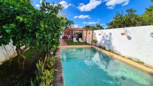a swimming pool in the backyard of a house at Hotel Monserrat in Mérida