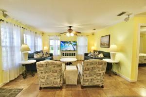 a living room with a couch and chairs at Pelican Cottage in Jensen Beach