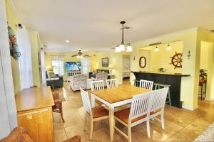 a dining room and living room with a table and chairs at Pelican Cottage in Jensen Beach