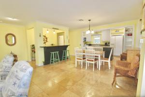 a kitchen and living room with a table and chairs at Pelican Cottage in Jensen Beach
