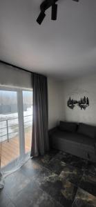 a living room with a couch and a window at Barnhous in Mykulychyn