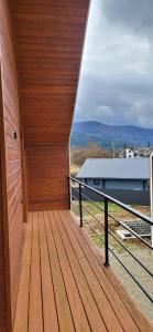 a wooden deck with a view of a building at Barnhous in Mykulychyn