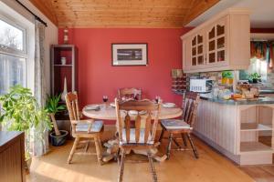 a kitchen with red walls and a table and chairs at 2 Bed in Staithes oc-wa071 in Staithes