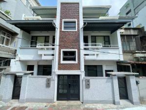 an apartment building with a door in front of it at 簃居青衖 in Tainan