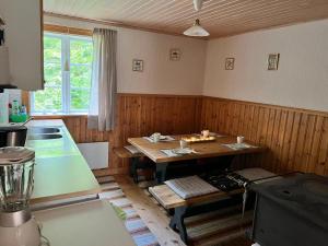 a kitchen with a table in the middle of a room at Urlaub im Elchland in Letafors