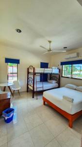 a bedroom with two bunk beds and a desk at Hotel Monserrat in Mérida