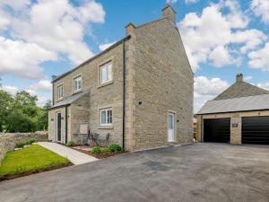 a large brick house with a garage at 4 Bed in Hope Valley oc-89431 in Bradwell