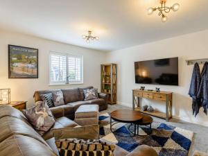 a living room with a couch and a table at 4 Bed in Hope Valley oc-89431 in Bradwell