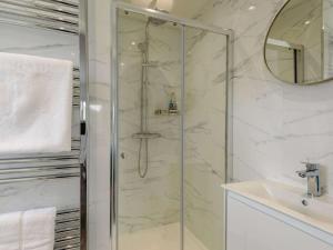 a bathroom with a glass shower and a sink at 4 Bed in Hope Valley oc-89431 in Bradwell +18 photos