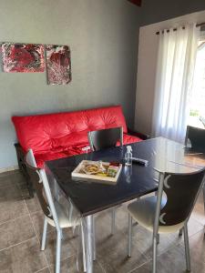 a dining room table with a plate of food on it at LA TORRE - Complejo de cabañas in Villa Rumipal