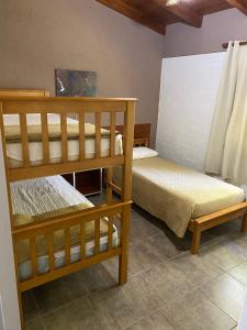 two bunk beds sitting in a room with at LA TORRE - Complejo de cabañas in Villa Rumipal +12 photos