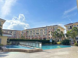 a large apartment building with a swimming pool at Arezzo Place Davao in Davao City