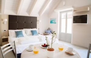 a bedroom with a bed and a table and chairs at Domus Residence in Domodossola