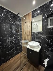 a black bathroom with a sink and a mirror at Codex Kolasin in Kolašin +19 photos