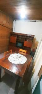 a dining room table with a white plate on it at Dpto en Santa María de Punilla in Córdoba +9 photos