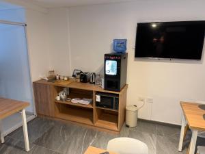 a living room with a tv on a wall at Hotel Plaza in Marcos Juárez
