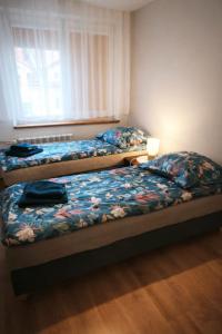 two beds sitting in a room with a window at Lubań Center in Lubań
