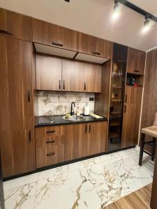 a kitchen with wooden cabinets and a sink at Codex Kolasin in Kolašin