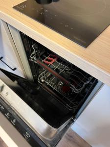 an oven with its door open in a kitchen at Гнёздышко in Visaginas +5 photos