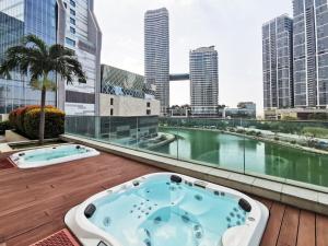 a hot tub on a deck with a view of a city at Cinnamon Life Residency in Colombo